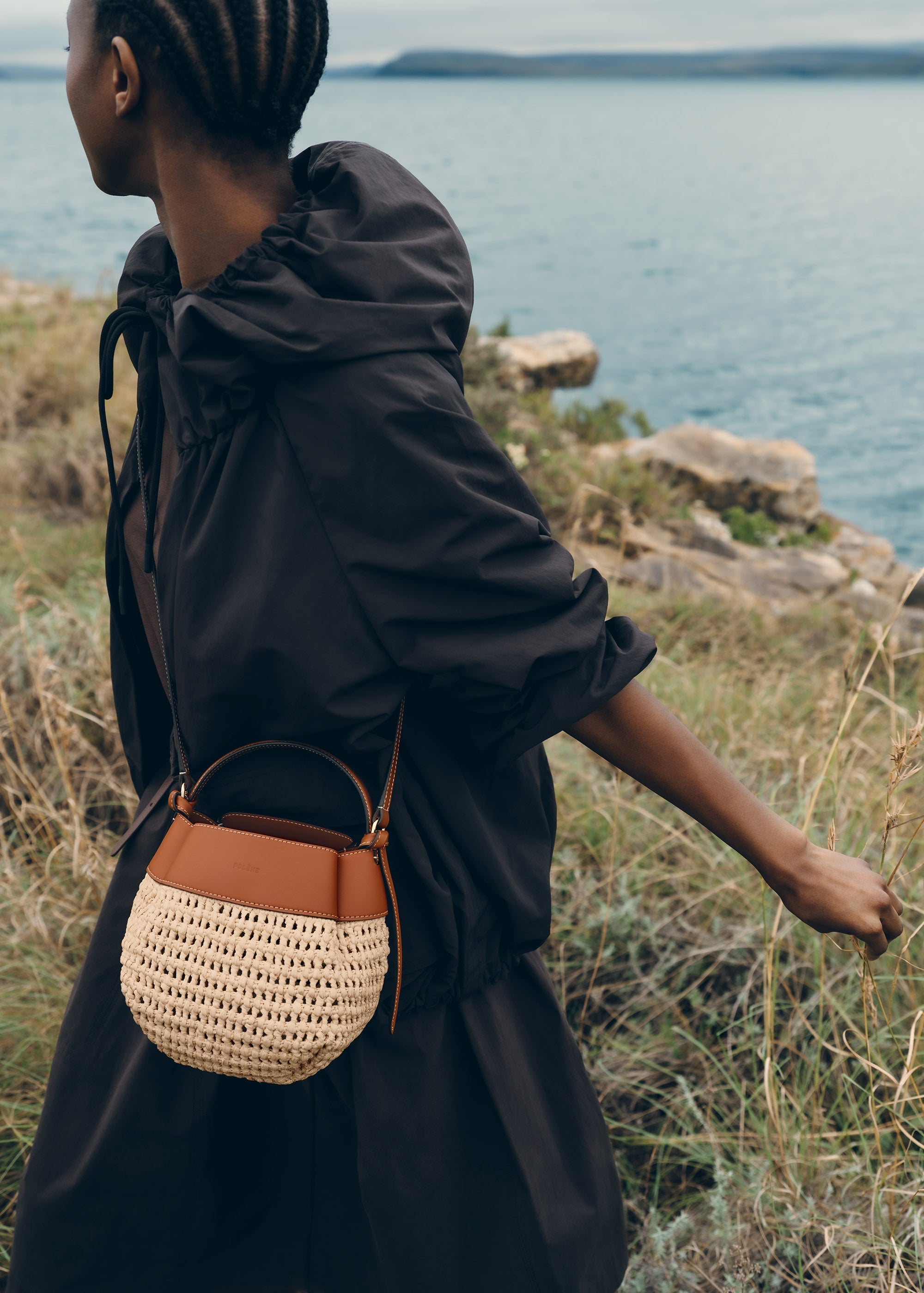 Polène Tsubi Raffia Summer 2026 lifestyle image, camel raffia carried on model